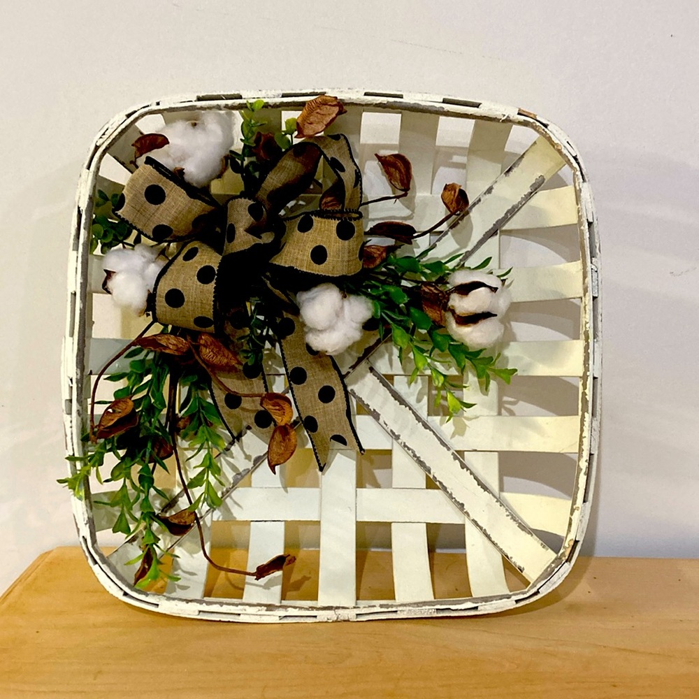 Wall Decor with natural cotton pods. Measures approximately 13x13x3.25”